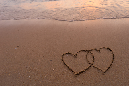 two hearts drawn in beachの写真素材