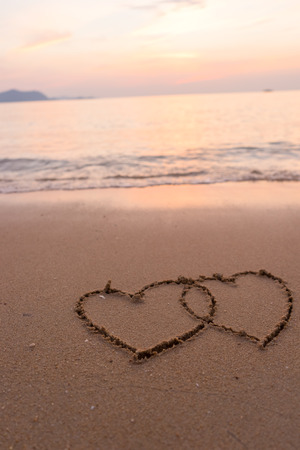 two hearts drawn in beachの写真素材