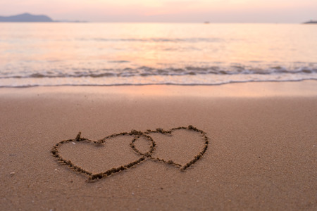 two hearts drawn in beachの写真素材