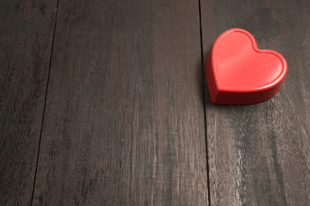 red heart pendant on a background of wood. Valentine's Day. Valentine day. Heart pendant. Red heart. Space for text. Eighth of March. International Women's Day.の写真素材