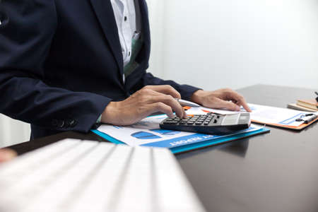 Man using calculator and writing make note with calculateの写真素材
