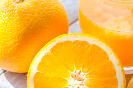Slice mandarin. Fresh orange juice on the table