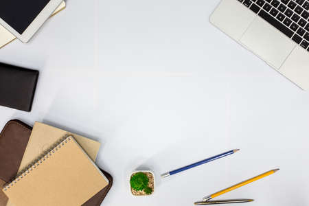 White office desk. table with blank notebook, tablet, calculator, computer and other office...