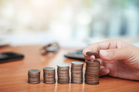 hand put coins to stack of coins. Business growth conceptsの写真素材