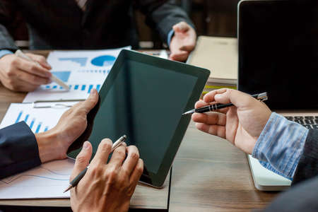 Business people meeting at working with financial reports and a tabletの写真素材