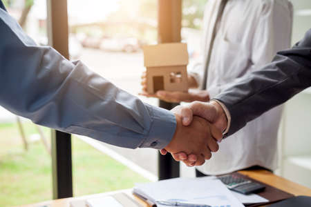 Business man shaking hands during a meeting in the office, Signing of the real estate sale agreement...