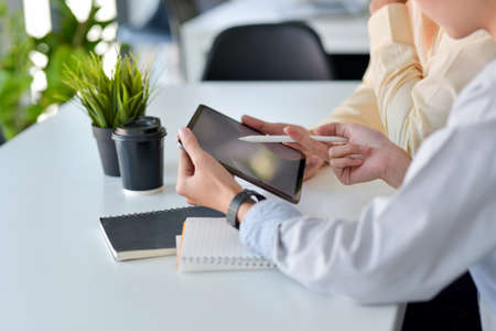 Image hands of a group of businessman work together point tablet at the office.