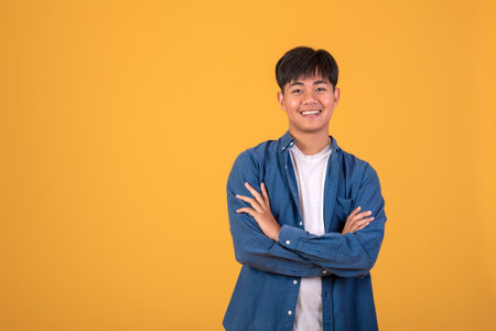 On orange background With a young Asian man Happy standing.の写真素材