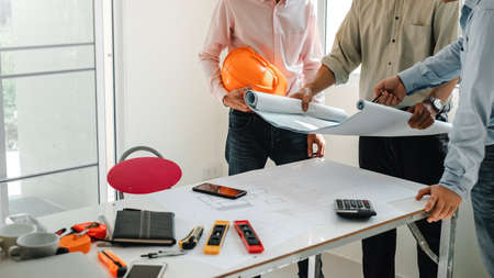 Team of architects and engineers to design and draft a construction project plan together.