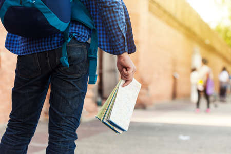 Tourists, young men carrying backpacks that are looking at the mapの写真素材