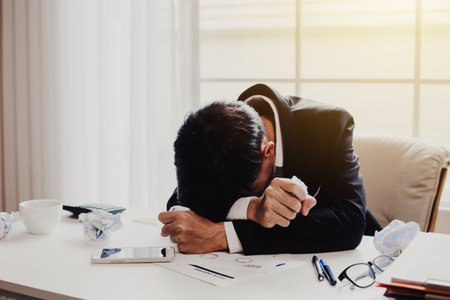 Businessman feeling sick and tired. Businessman who feel stressed out of workの写真素材