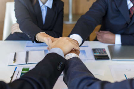 Business people together to work as a team to ensure the success of the business. Teamwork cooperation togetherness conceptの写真素材