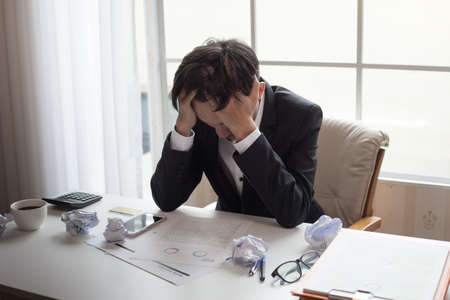 Business man unhappy in their work. Despair failed to work.の写真素材