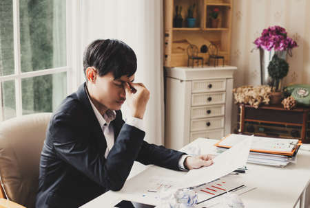 Businessman feeling sick and tired. Businessman who feel stressed out of workの写真素材