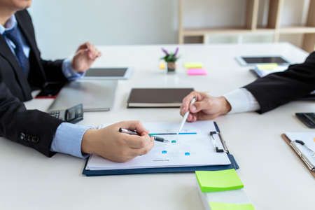 Group of business people meeting analyzing financial documentsの写真素材