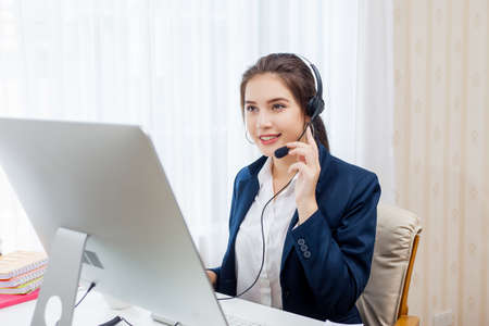 Beautiful young woman working in call centre.の写真素材