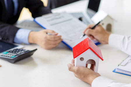Real estate broker and customer signing a contract. Trading house for rent and insuranceの写真素材