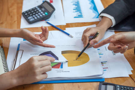 Business woman at working with financial reports and laptop computer in the officeの写真素材
