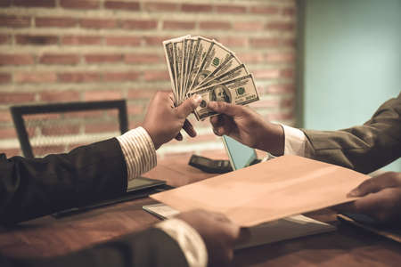 Business woman at working with financial reports and laptop computer in the officeの写真素材