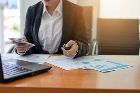 Business woman at working with financial reports and laptop computer in the officeの写真素材