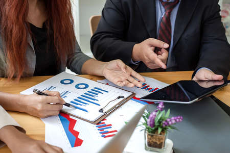 Business people at working with financial reports and a tabletの写真素材