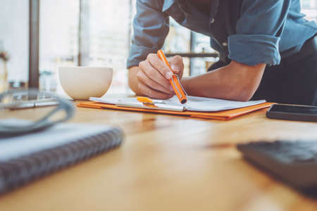 Business man working document in office morning light.の写真素材