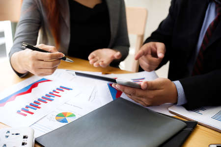 Business people at working with financial reports and a tablet