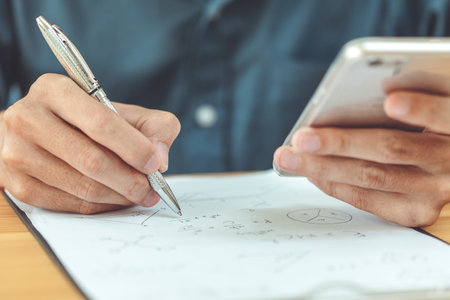 Engineers using a pen recorded data on the deskの写真素材