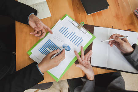 Teamwork process, business people working in the office discussing documents and ideas at meetingの写真素材