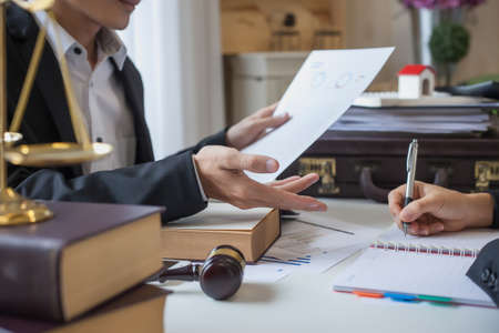 Business lawyer working about legal legislation in courtroom to help their customerの写真素材
