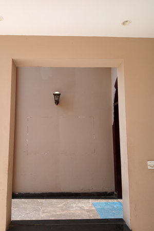 Interior of a room with brown walls, door and window.の写真素材