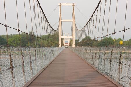 wood bridge brown across the river long way grating pierThailandの写真素材