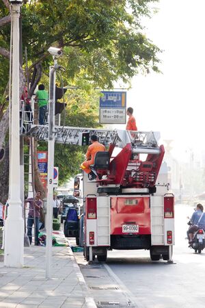 Bangkok 20 April 2013 :Firefighter hustle to set up big poster for advertisment a project "Bangkok world book 2013"のeditorial素材