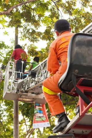 Bangkok 20 April 2013 :Firefighter hustle to set up big poster for advertisment a project  "Bangkok world book 2013"のeditorial素材