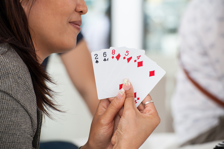 woman play card with friend