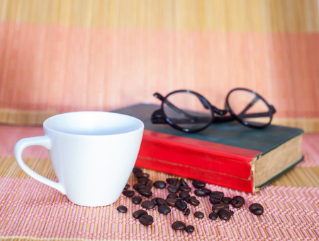 Cup of hot drink with coffee beansの写真素材