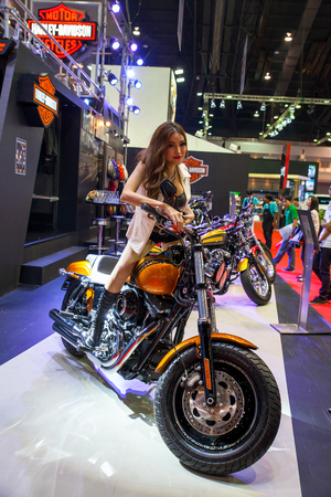 BANGKOK - MARCH 26   Unidentified pretty girl display on Harley-Davidson  at The 35th Bangkok International Motor Show 2014 on March 26, 2014 in Bangkok, Thailand のeditorial素材