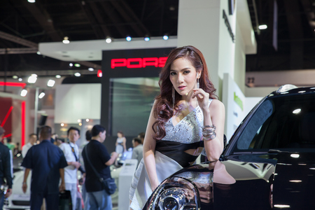 NONTHABURI - March 26: Unidentified modellings posted over Porsche 911 Macan Turbo  display on stage at The 35th Bangkok 
International Motor Show on March 26, 2014 in Nonthaburi, Thailand.のeditorial素材