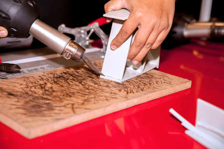 BANGKOK - JUNE 22 :Worker weld PV with hot air  at 
Manufacturing Expo 2014 on June 22,2014 ,Bangkok, Thailand.のeditorial素材
