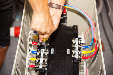 BANGKOK - JUNE 22  Men repair a transformers at Manufacturing Expo 2014 2014 on June 22,2014 in BITEC ,Bangkok, Thailand のeditorial素材
