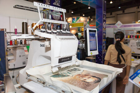 BANGKOK - JUNE 28  Textile embroidery machine in Textile Industry at Garment Manufacturers Sourcing 2014 on June 28,2014 in BITEC ,Bangkok, Thailand のeditorial素材