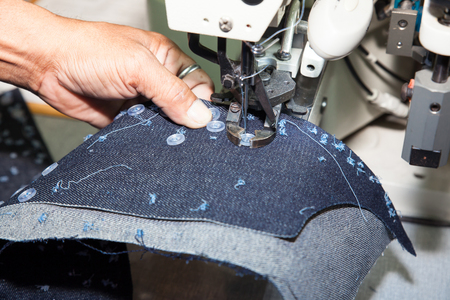 BANGKOK - JUNE 28  Auto sewing buttons machine at Garment Manufacturers Sourcing 2014 on June 28,2014 in BITEC ,Bangkok, Thailand のeditorial素材