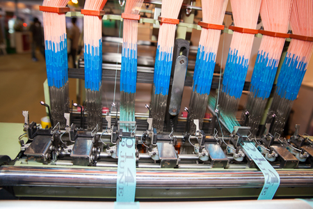 BANGKOK - JUNE 28  Textile machine with colors threads at Garment Manufacturers Sourcing 2014 on June 28,2014 in BITEC ,Bangkok, Thailand のeditorial素材