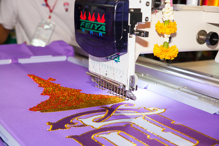 BANGKOK - JUNE 28  Textile embroidery machine in Textile Industry at Garment Manufacturers Sourcing 2014 on June 28,2014 in BITEC ,Bangkok, Thailand のeditorial素材