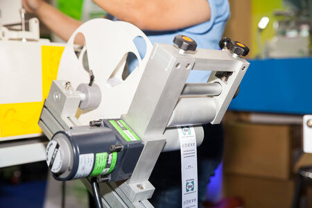 BANGKOK - JUNE 28  Cutting the shirt labels  machine at Garment Manufacturers Sourcing 2014 on June 28,2014 in BITEC ,Bangkok, Thailand のeditorial素材