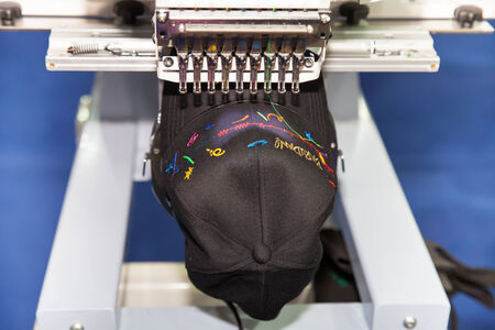 BANGKOK - JUNE 28  Cap on embroidery machine at Garment Manufacturers Sourcing 2014 on June 28,2014...