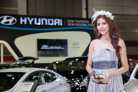 BANGKOK - AUGUST 16 :An unidentified female presenter models at HYUNDAI booth at Big Motor Sale 2014 on June 16,2014 in BITEC ,Bangkok, Thailand.のeditorial素材
