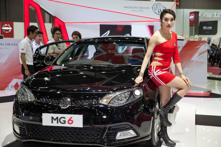 BANGKOK - AUGUST 16 :An unidentified female presenter models at MG Motor booth at Big Motor Sale 2014 on June 16,2014 in BITEC ,Bangkok, Thailand.のeditorial素材