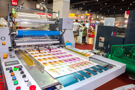BANGKOK - SEPTEMBER 27 :Plastic coating on paper machines display at GASMA PRINT 2014 on Sep 27,2014 in BITEC ,Bangkok, Thailand.のeditorial素材