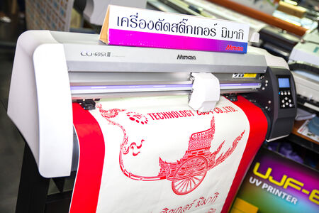 BANGKOK - SEPTEMBER 27 : cutting machines at GASMA PRINT 2014 on Sep 27,2014 in BITEC ,Bangkok, Thailand.のeditorial素材